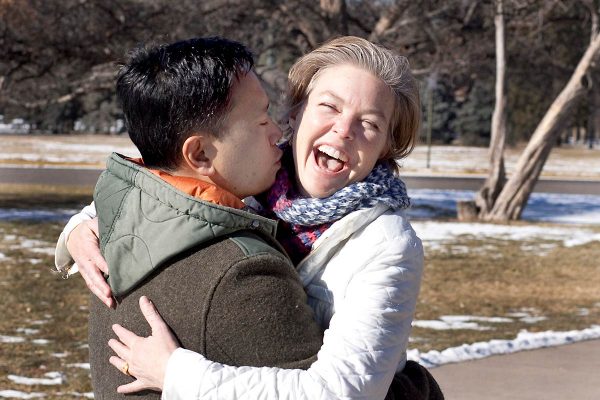husband picks up and kisses his wife as she laughs, showing gratitude for being alive thanks to using ECMO for his acute respiratory distress syndrome.
