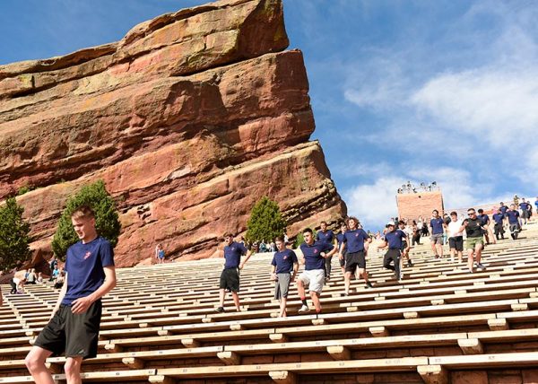 Marine recruits run down the bleacher seats at Red Rocks.