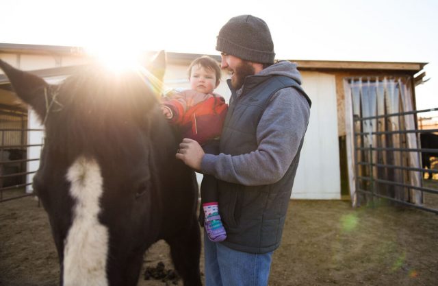 Jacob Bailey with daughter Bobbi and one of seven horses he tends to at the family’s stables east of Parker. Because of a trial, he is taking aggressive treatment for multiple sclerosis.